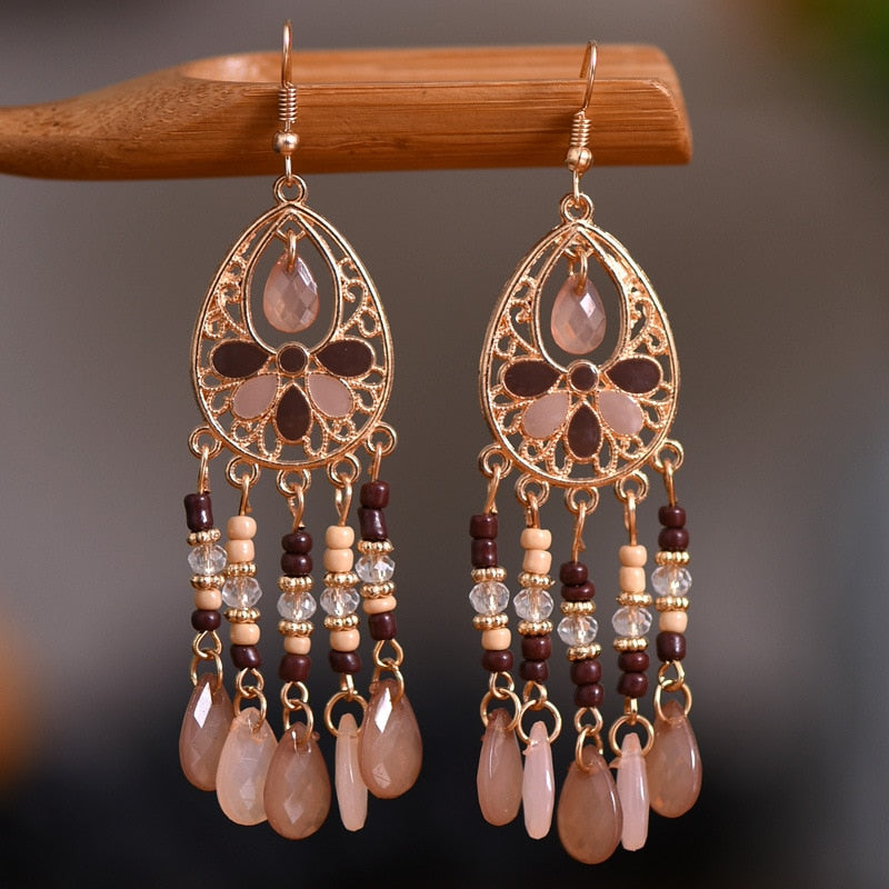 These Bohema Ethnic Fringed Tassel Earrings boast a stylish geometric shape and are crafted with a glossy acrylic water drop. Women of all ages will love wearing these beautiful metal earrings.