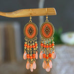 These Bohema Ethnic Fringed Tassel Earrings boast a stylish geometric shape and are crafted with a glossy acrylic water drop. Women of all ages will love wearing these beautiful metal earrings.