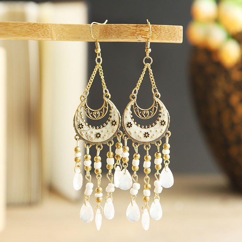 These Bohema Ethnic Fringed Tassel Earrings boast a stylish geometric shape and are crafted with a glossy acrylic water drop. Women of all ages will love wearing these beautiful metal earrings.