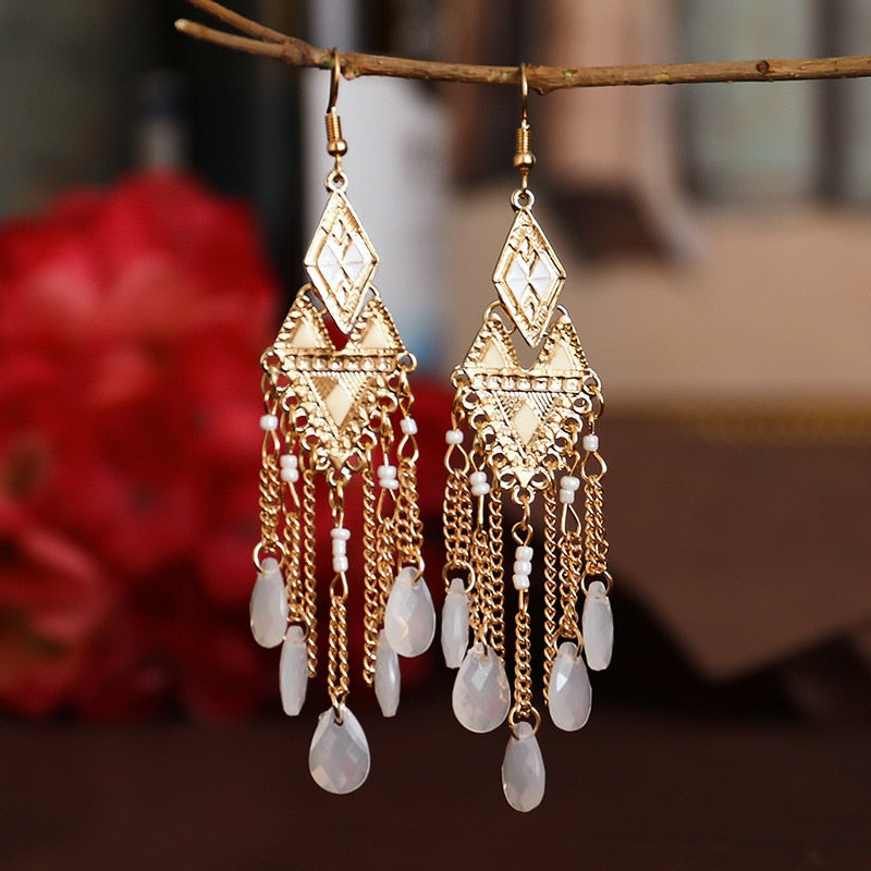 These Bohema Ethnic Fringed Tassel Earrings boast a stylish geometric shape and are crafted with a glossy acrylic water drop. Women of all ages will love wearing these beautiful metal earrings.