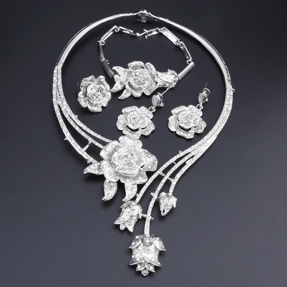 Enhance your wedding day style with this elegant jewelry set, consisting of a gold-colored crystal rose flower necklace, earrings, ring, and bangle, ideal for bridal accessories.