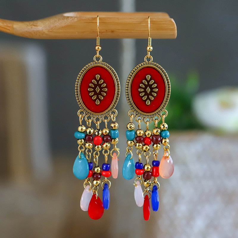 These Bohema Ethnic Fringed Tassel Earrings boast a stylish geometric shape and are crafted with a glossy acrylic water drop. Women of all ages will love wearing these beautiful metal earrings.