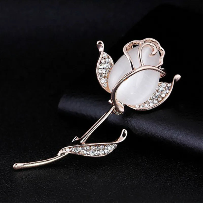 A stunning collection of opal stone and rhinestone brooches featuring rose flower designs. These exquisite brooches are perfect for women to accessorize their fashion clothing, especially for weddings. They make wonderful gifts for any occasion and are a must-have addition to any jewelry collection.