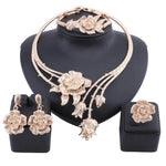 Enhance your wedding day style with this elegant jewelry set, consisting of a gold-colored crystal rose flower necklace, earrings, ring, and bangle, ideal for bridal accessories.