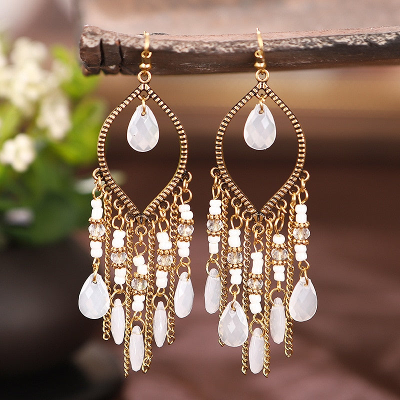 These Bohema Ethnic Fringed Tassel Earrings boast a stylish geometric shape and are crafted with a glossy acrylic water drop. Women of all ages will love wearing these beautiful metal earrings.