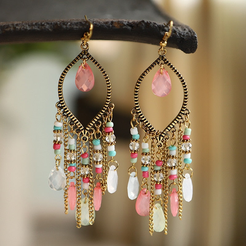 These Bohema Ethnic Fringed Tassel Earrings boast a stylish geometric shape and are crafted with a glossy acrylic water drop. Women of all ages will love wearing these beautiful metal earrings.