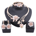 Enhance your wedding day style with this elegant jewelry set, consisting of a gold-colored crystal rose flower necklace, earrings, ring, and bangle, ideal for bridal accessories.