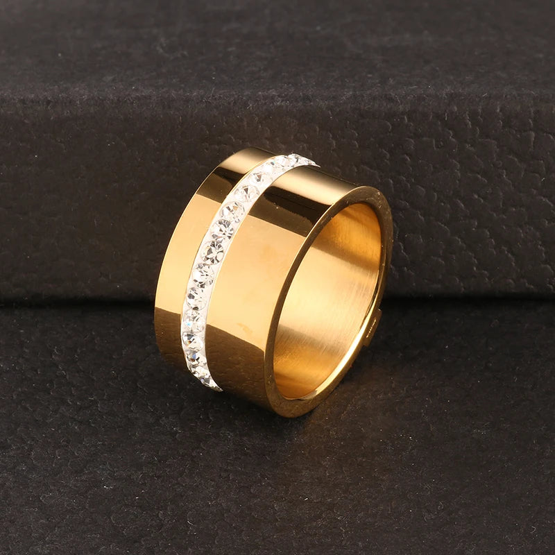 Elevate your style with our exquisite collection of wide rings for women. Crafted from high-quality stainless steel, these silver-colored rings feature a single row of sparkling cubic zirconia, adding a touch of luxury to any outfit. Perfect for wedding bands or everyday wear, these rings are designed to make a statement and enhance your femininity. Explore our range and find the perfect ring for you.