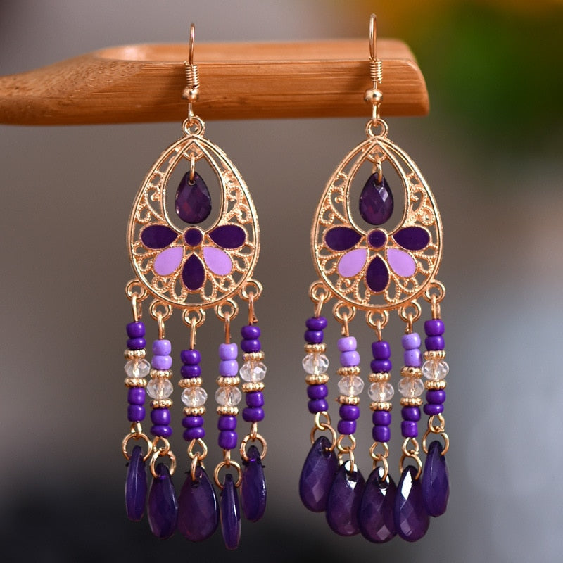 These Bohema Ethnic Fringed Tassel Earrings boast a stylish geometric shape and are crafted with a glossy acrylic water drop. Women of all ages will love wearing these beautiful metal earrings.