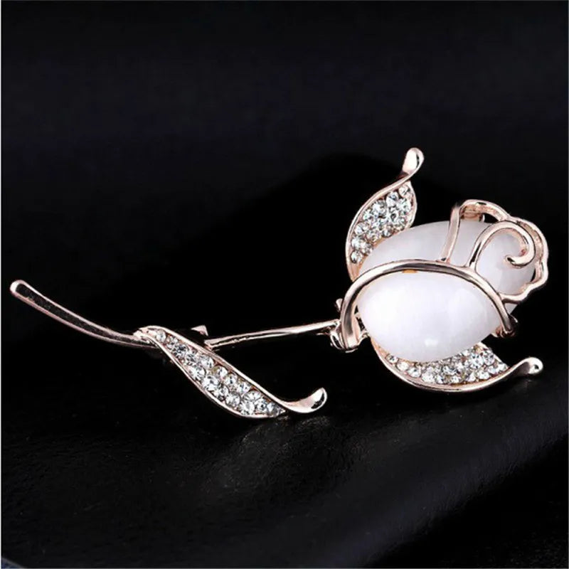 A stunning collection of opal stone and rhinestone brooches featuring rose flower designs. These exquisite brooches are perfect for women to accessorize their fashion clothing, especially for weddings. They make wonderful gifts for any occasion and are a must-have addition to any jewelry collection.