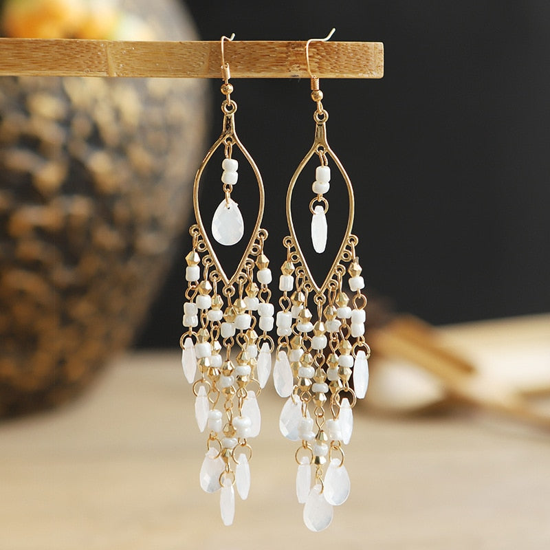 These Bohema Ethnic Fringed Tassel Earrings boast a stylish geometric shape and are crafted with a glossy acrylic water drop. Women of all ages will love wearing these beautiful metal earrings.