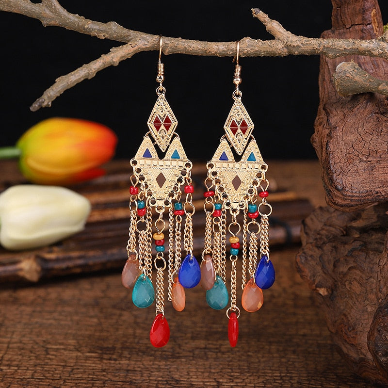 These Bohema Ethnic Fringed Tassel Earrings boast a stylish geometric shape and are crafted with a glossy acrylic water drop. Women of all ages will love wearing these beautiful metal earrings.