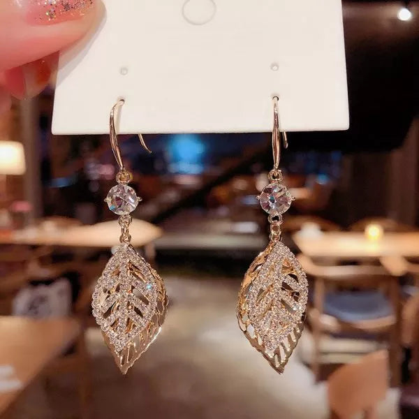 The allure of these exquisite French vintage earrings adorned with red maple leaf crystals and zircon stones. These elegant tassel earrings are designed to enhance a woman's temperament and add a touch of glamour to any party ensemble. They make a perfect gift for someone special who appreciates fine jewelry.