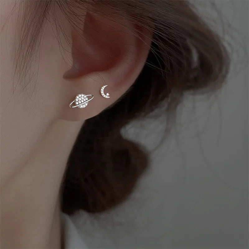 Elegant and minimalist stud earrings designed for women, featuring star and moon motifs with sparkling zircon stones. Crafted from high-quality 925 silver, these earrings are perfect for tragus and cartilage piercings, adding a touch of asymmetrical charm to your fine jewelry collection.