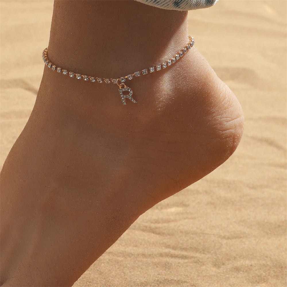 This ankle bracelet features an initial letter design with crystal zircon accents, perfect for women looking for a stylish foot chain to wear at the beach or as boho jewelry.