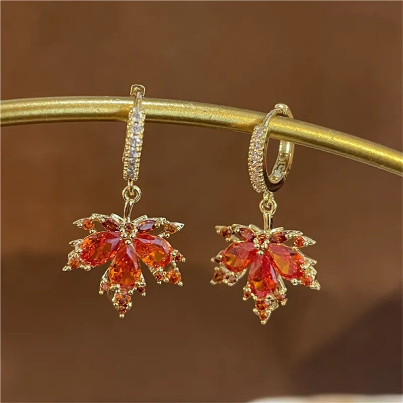 The allure of these exquisite French vintage earrings adorned with red maple leaf crystals and zircon stones. These elegant tassel earrings are designed to enhance a woman's temperament and add a touch of glamour to any party ensemble. They make a perfect gift for someone special who appreciates fine jewelry.