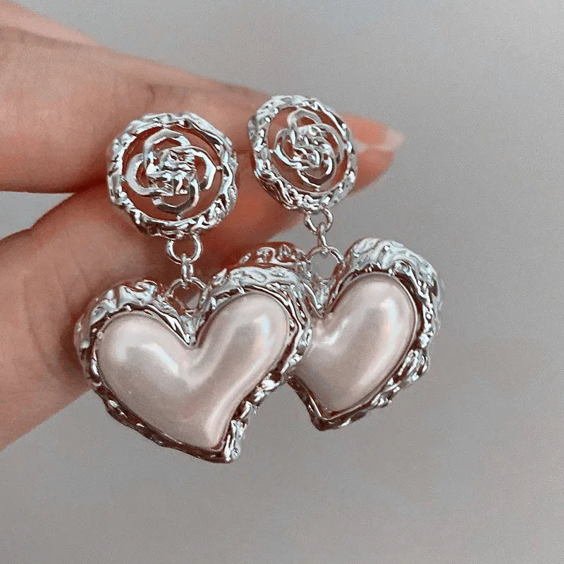 The latest addition to our collection, the Flower Heart Earrings . These French-inspired retro fashion accessories are the epitome of luxury, designed exclusively for women. Perfect for weddings and special occasions, these earrings are a must-have in every jewelry collection.