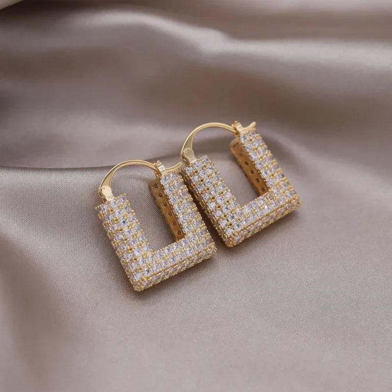 Introducing the elegant women's wedding party accessories, we present the luxurious square zircon pendant earrings in 16K gold plated fashion jewelry from Korea. This new design is sure to add a touch of sophistication to any outfit.