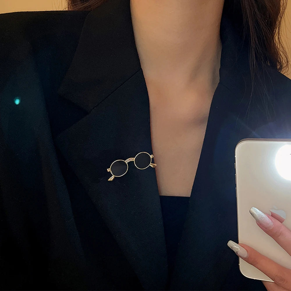 Unique vintage metal glasses shaped pins that add a touch of punk style to your outfit. These mini sunglasses brooches are perfect for both women and men, making them versatile accessories for any party or special occasion. Elevate your clothing game with these trendy and eye-catching pieces.