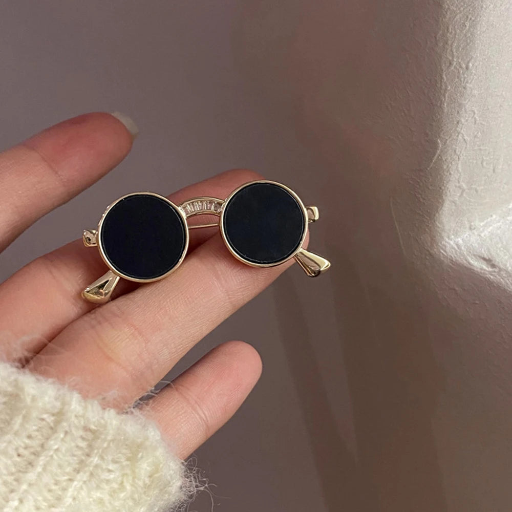 Unique vintage metal glasses shaped pins that add a touch of punk style to your outfit. These mini sunglasses brooches are perfect for both women and men, making them versatile accessories for any party or special occasion. Elevate your clothing game with these trendy and eye-catching pieces.