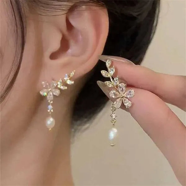 The allure of these exquisite French vintage earrings adorned with red maple leaf crystals and zircon stones. These elegant tassel earrings are designed to enhance a woman's temperament and add a touch of glamour to any party ensemble. They make a perfect gift for someone special who appreciates fine jewelry.