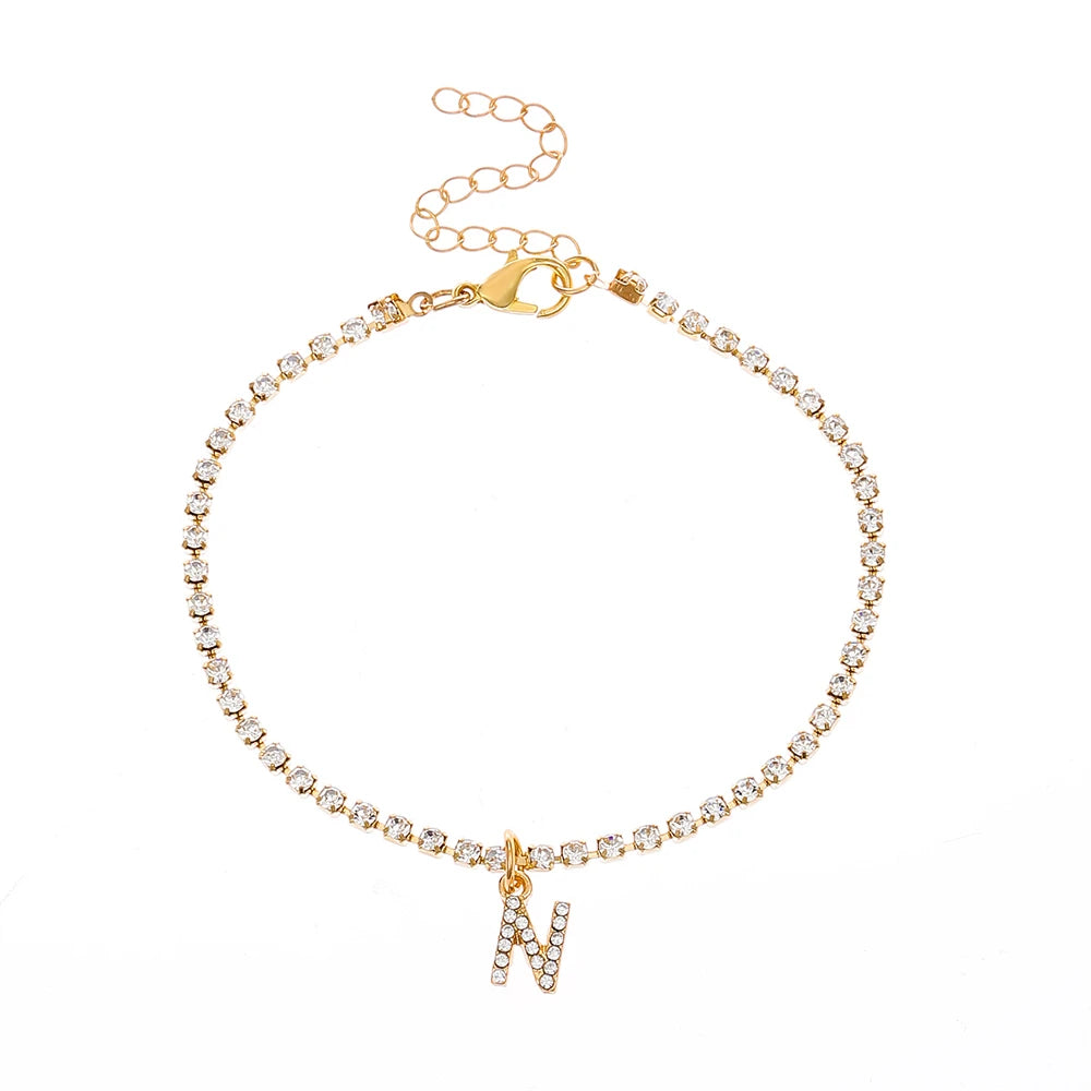 This ankle bracelet features an initial letter design with crystal zircon accents, perfect for women looking for a stylish foot chain to wear at the beach or as boho jewelry.