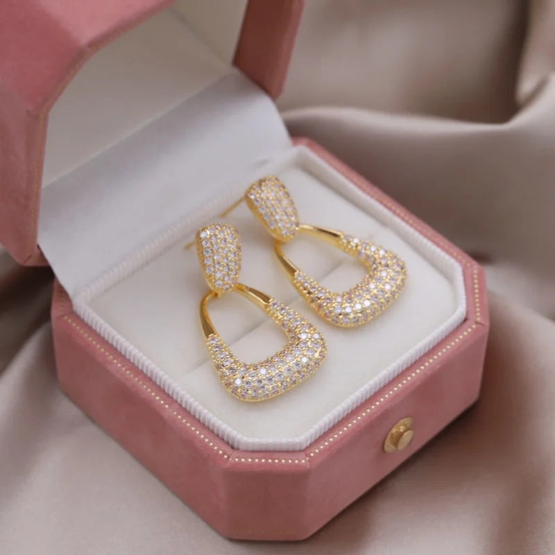 Introducing the elegant women's wedding party accessories, we present the luxurious square zircon pendant earrings in 16K gold plated fashion jewelry from Korea. This new design is sure to add a touch of sophistication to any outfit.