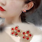 The allure of these exquisite French vintage earrings adorned with red maple leaf crystals and zircon stones. These elegant tassel earrings are designed to enhance a woman's temperament and add a touch of glamour to any party ensemble. They make a perfect gift for someone special who appreciates fine jewelry.