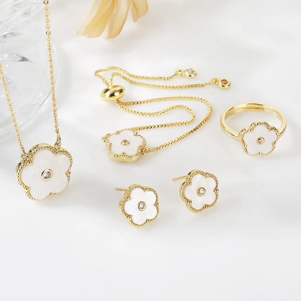 The exquisite elegance of our exclusive 18K gold plated Clover Flower Necklace Earrings Bracelet Ring Women Set. This stunning jewelry set is not only a symbol of luxury but also a perfect gift for any bride. Don't miss out on our limited-time offer with a low price that will leave you amazed.