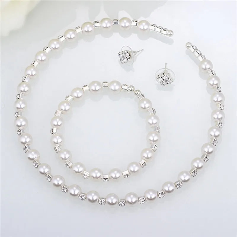 Enhance your bridal party's look with this stunning set of pearl crystal bridesmaid wedding jewelry, including a necklace, bracelet, and earrings. Elevate your bridesmaids' style with this elegant and timeless accessory set.