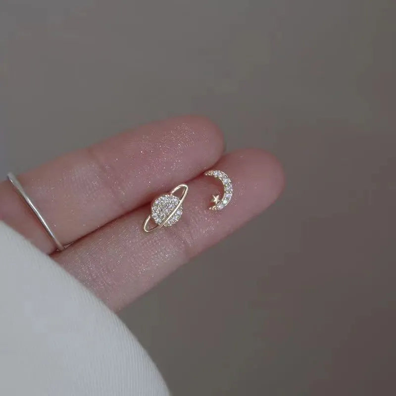 Elegant and minimalist stud earrings designed for women, featuring star and moon motifs with sparkling zircon stones. Crafted from high-quality 925 silver, these earrings are perfect for tragus and cartilage piercings, adding a touch of asymmetrical charm to your fine jewelry collection.