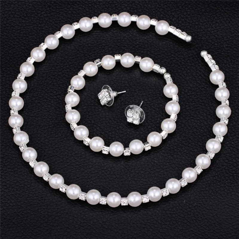 Enhance your bridal party's look with this stunning set of pearl crystal bridesmaid wedding jewelry, including a necklace, bracelet, and earrings. Elevate your bridesmaids' style with this elegant and timeless accessory set.