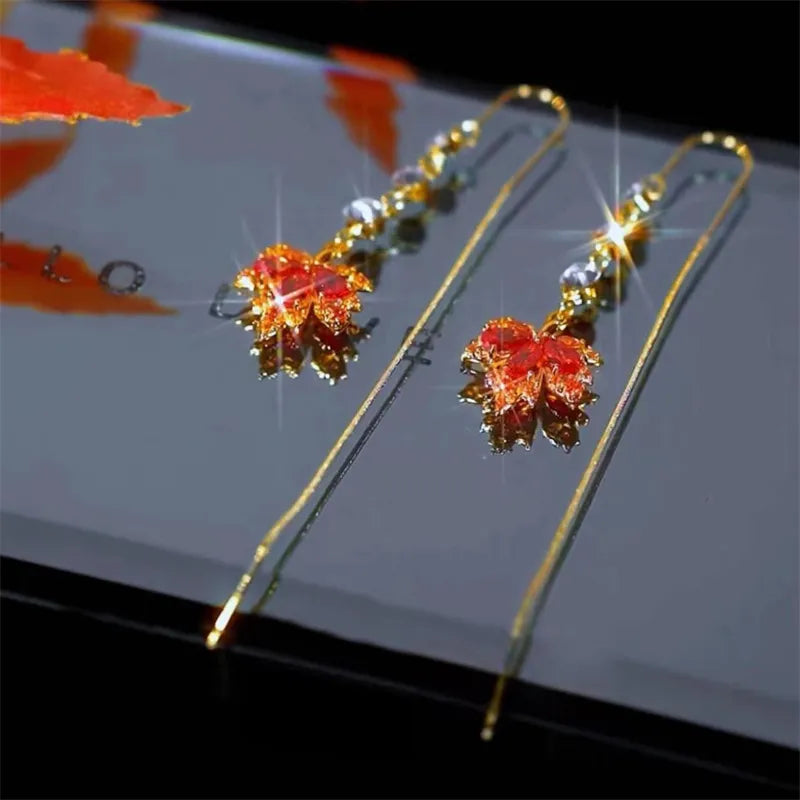 The allure of these exquisite French vintage earrings adorned with red maple leaf crystals and zircon stones. These elegant tassel earrings are designed to enhance a woman's temperament and add a touch of glamour to any party ensemble. They make a perfect gift for someone special who appreciates fine jewelry.