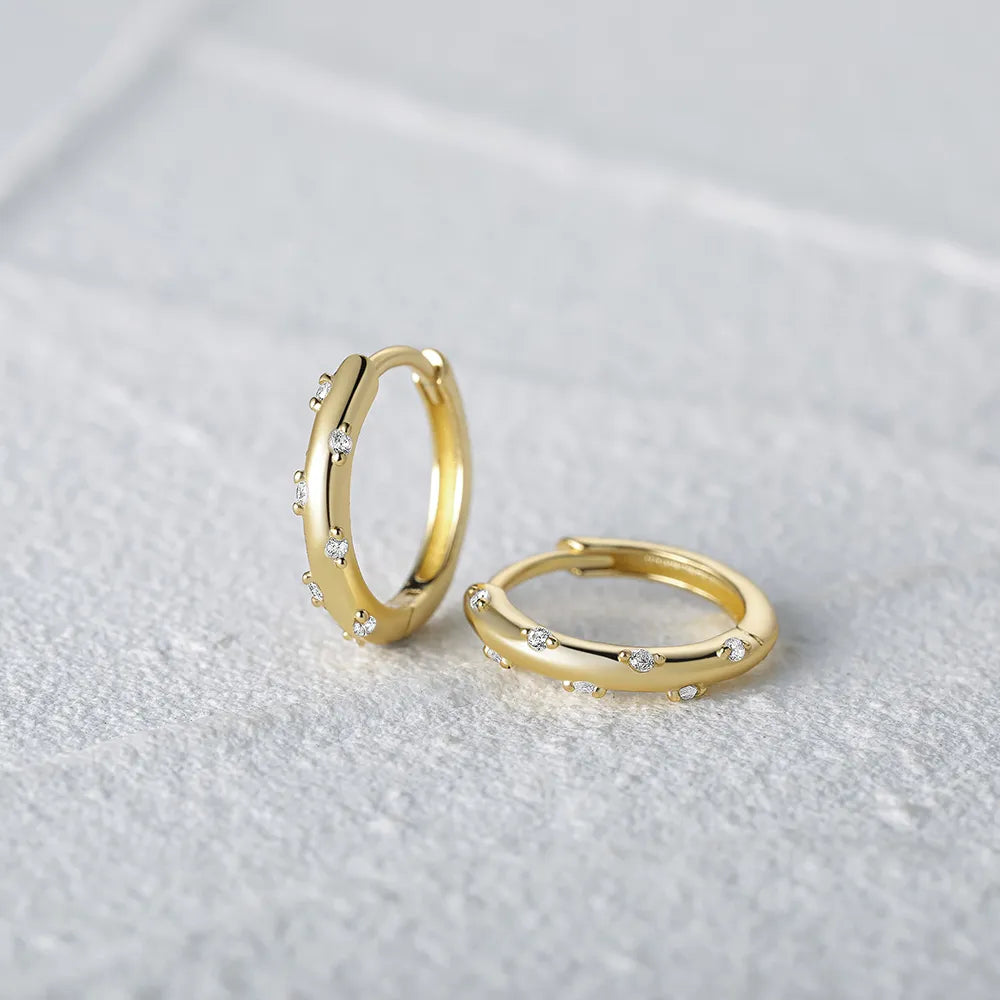 These small huggie earrings are made of 925 sterling silver with a glossy gold color finish, perfect for cartilage piercings. The fine jewelry accessories are designed to add a touch of elegance to any outfit.