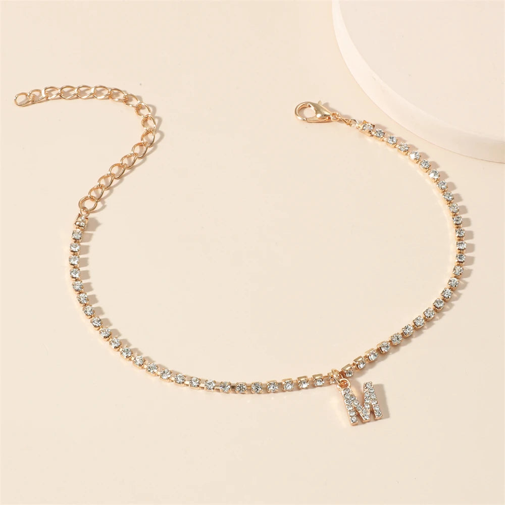 This ankle bracelet features an initial letter design with crystal zircon accents, perfect for women looking for a stylish foot chain to wear at the beach or as boho jewelry.