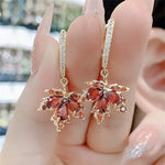 The allure of these exquisite French vintage earrings adorned with red maple leaf crystals and zircon stones. These elegant tassel earrings are designed to enhance a woman's temperament and add a touch of glamour to any party ensemble. They make a perfect gift for someone special who appreciates fine jewelry.