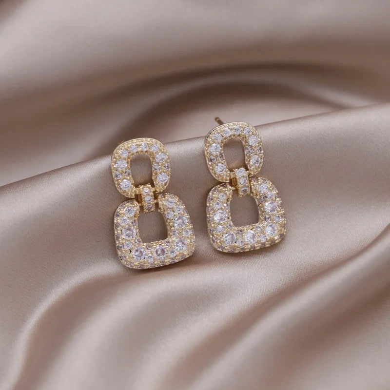 Introducing the elegant women's wedding party accessories, we present the luxurious square zircon pendant earrings in 16K gold plated fashion jewelry from Korea. This new design is sure to add a touch of sophistication to any outfit.