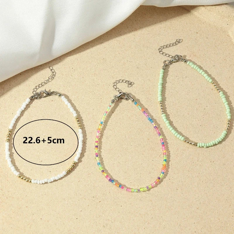 Enhance your summer look with this set of three Bohemian anklets adorned with colorful beaded beads, perfect for a day at the beach or a stroll along the ocean. Handmade with care, these ankle bracelets make a lovely gift for any woman looking to add a touch of boho chic to her outfit.