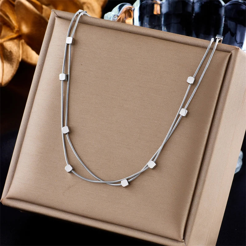 This necklace is made of 316L stainless steel and features a 2-in-1 design with small cube chains. It is available in gold and silver colors, making it a stylish accessory for women. This choker necklace is perfect for parties and also makes a great jewelry gift for girls.