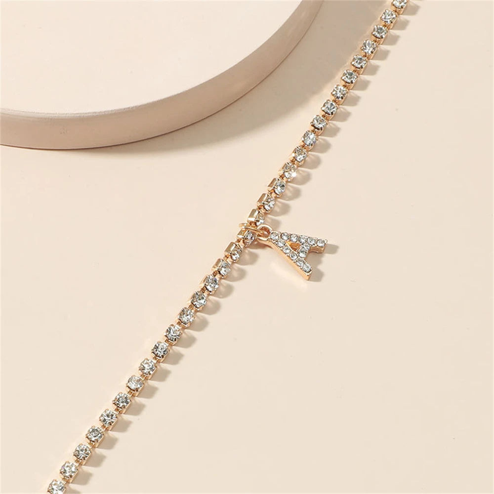 This ankle bracelet features an initial letter design with crystal zircon accents, perfect for women looking for a stylish foot chain to wear at the beach or as boho jewelry.