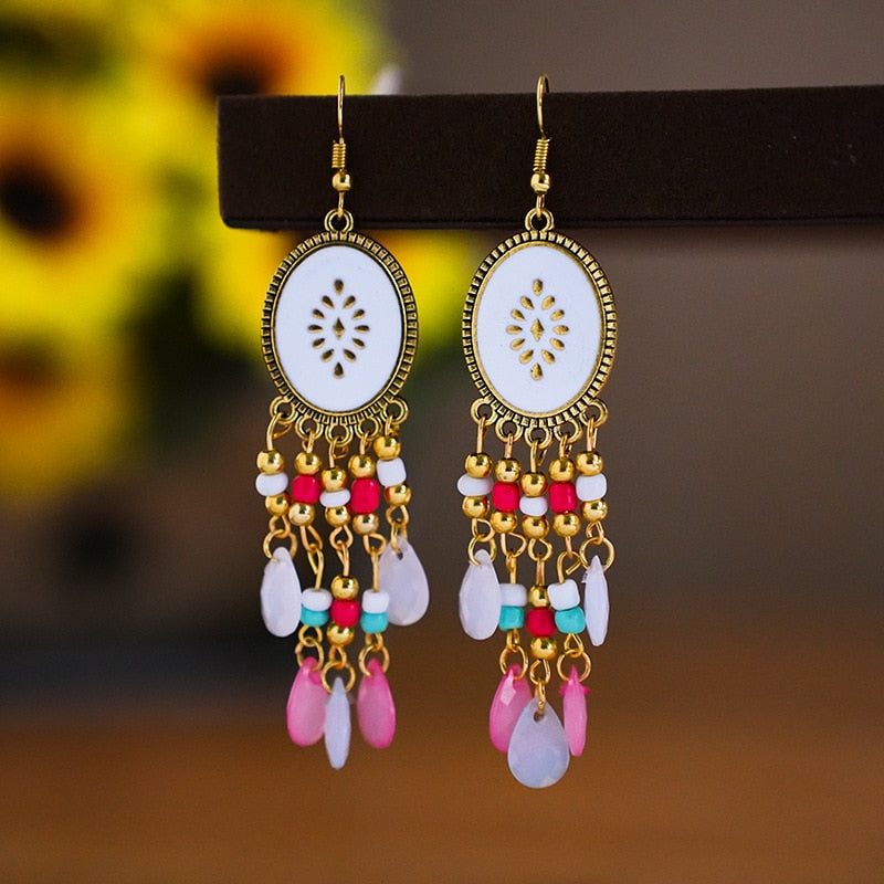 These Bohema Ethnic Fringed Tassel Earrings boast a stylish geometric shape and are crafted with a glossy acrylic water drop. Women of all ages will love wearing these beautiful metal earrings.