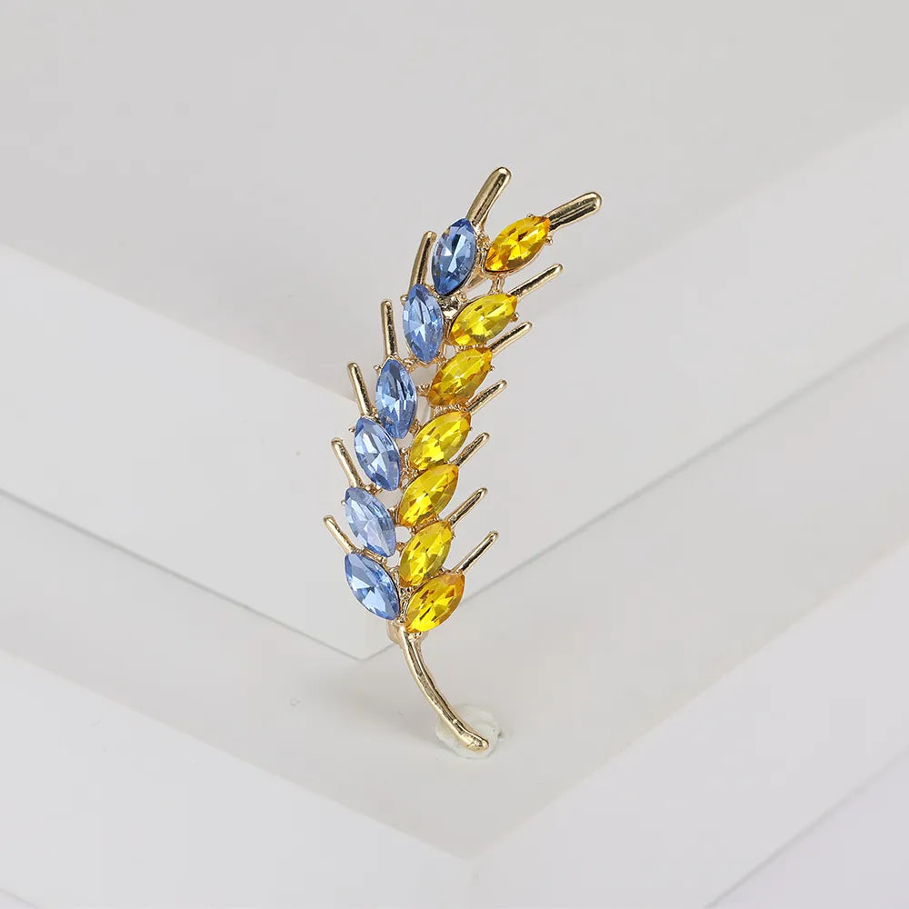 Elevate your style with these exquisite Korean fashion-inspired women's brooches. Crafted with attention to detail, these lapel pins feature a stunning 3-color rhinestone design resembling an ear of wheat. Perfect for adding a touch of luxury to your clothing, these jewelry accessories are a must-have for any fashion enthusiast.