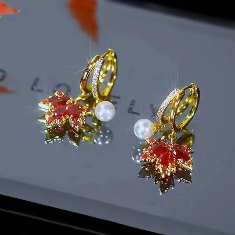 The allure of these exquisite French vintage earrings adorned with red maple leaf crystals and zircon stones. These elegant tassel earrings are designed to enhance a woman's temperament and add a touch of glamour to any party ensemble. They make a perfect gift for someone special who appreciates fine jewelry.