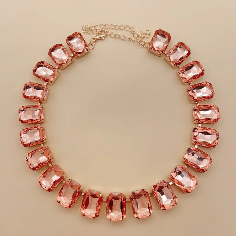 Elevate your style with this exquisite piece of jewelry - a luxurious, classic, and shiny pink champagne crystal necklace. The adjustable square pendant, adorned with a large glass centerpiece, adds a touch of elegance to your clavicle chain. Embrace the fashion-forward design and make a statement with this stunning fashion accessory.