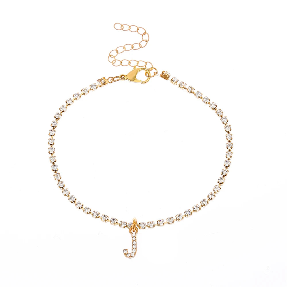 This ankle bracelet features an initial letter design with crystal zircon accents, perfect for women looking for a stylish foot chain to wear at the beach or as boho jewelry.