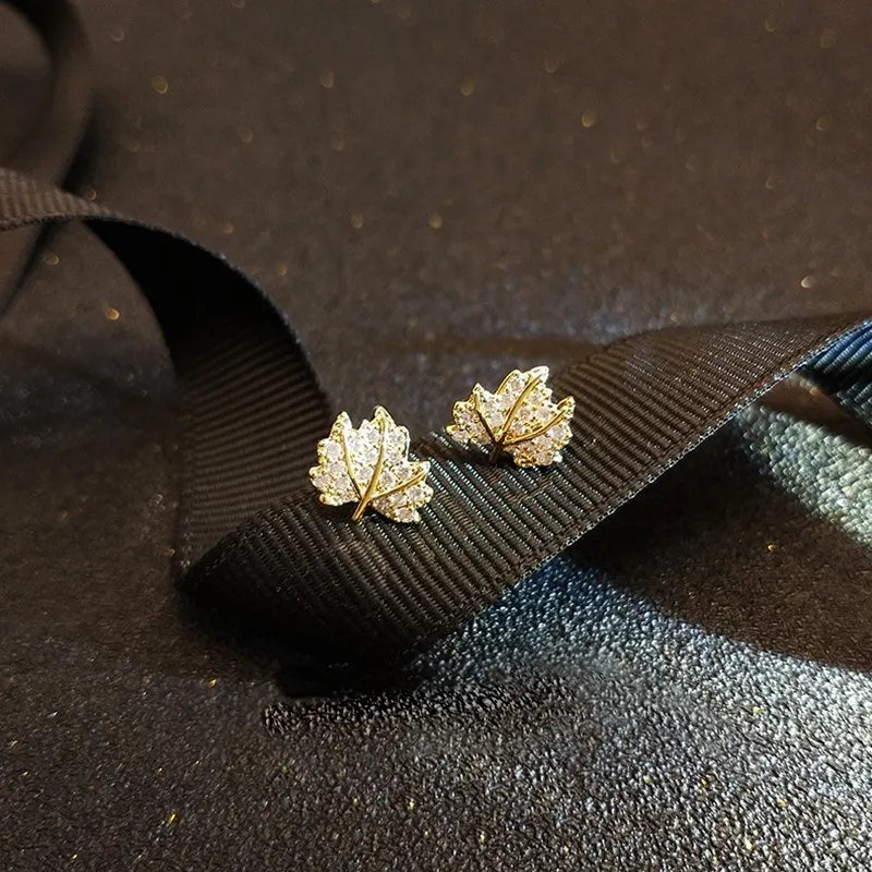 The allure of these exquisite French vintage earrings adorned with red maple leaf crystals and zircon stones. These elegant tassel earrings are designed to enhance a woman's temperament and add a touch of glamour to any party ensemble. They make a perfect gift for someone special who appreciates fine jewelry.