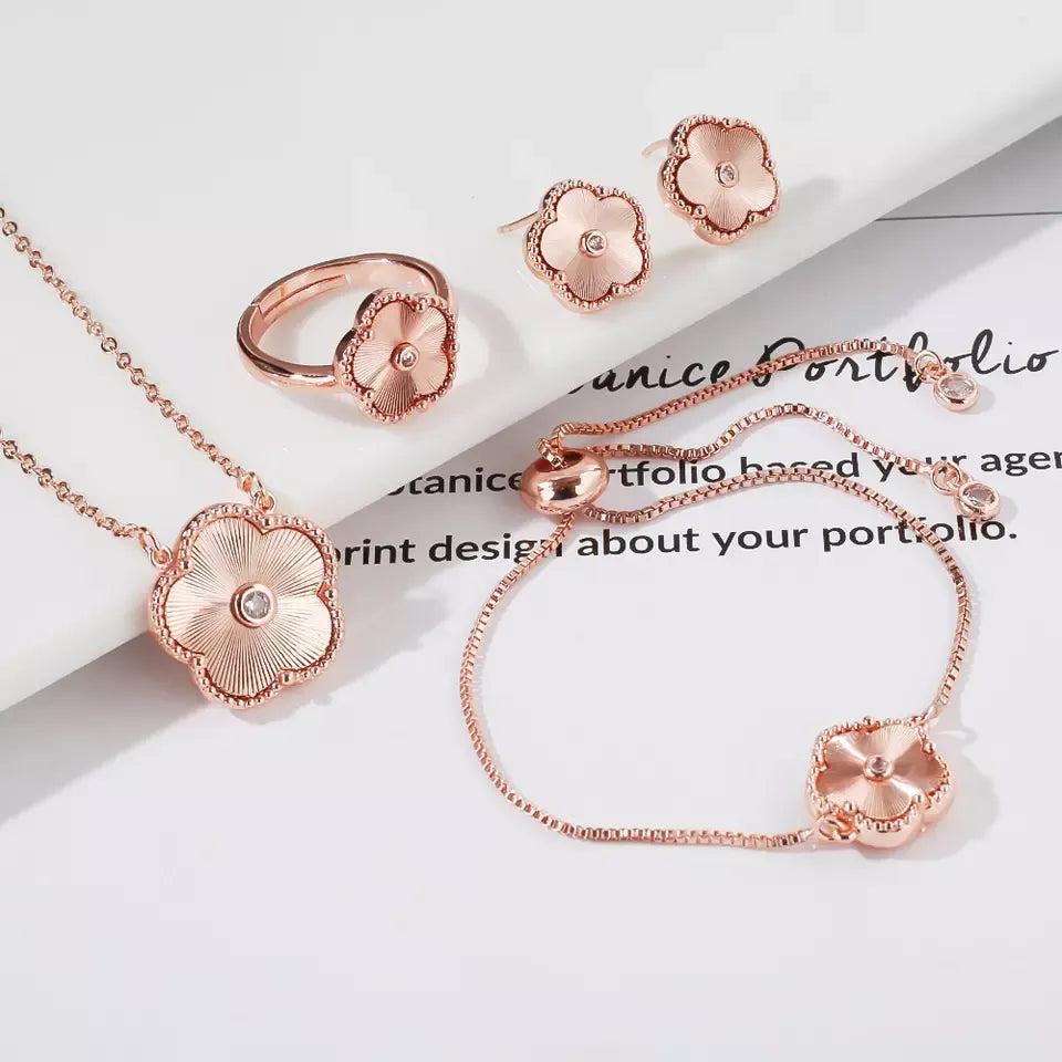 The exquisite elegance of our exclusive 18K gold plated Clover Flower Necklace Earrings Bracelet Ring Women Set. This stunning jewelry set is not only a symbol of luxury but also a perfect gift for any bride. Don't miss out on our limited-time offer with a low price that will leave you amazed.