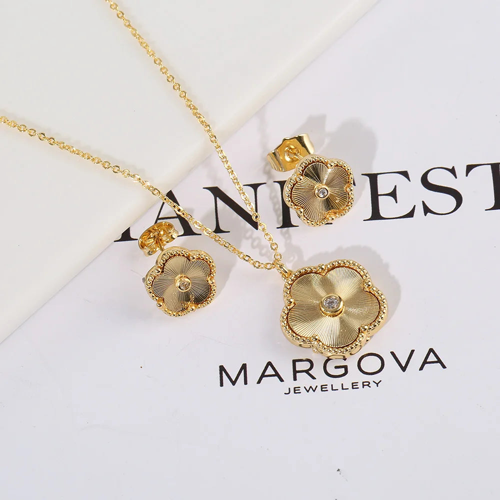 The exquisite elegance of our exclusive 18K gold plated Clover Flower Necklace Earrings Bracelet Ring Women Set. This stunning jewelry set is not only a symbol of luxury but also a perfect gift for any bride. Don't miss out on our limited-time offer with a low price that will leave you amazed.