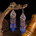 These Bohema Ethnic Fringed Tassel Earrings boast a stylish geometric shape and are crafted with a glossy acrylic water drop. Women of all ages will love wearing these beautiful metal earrings.