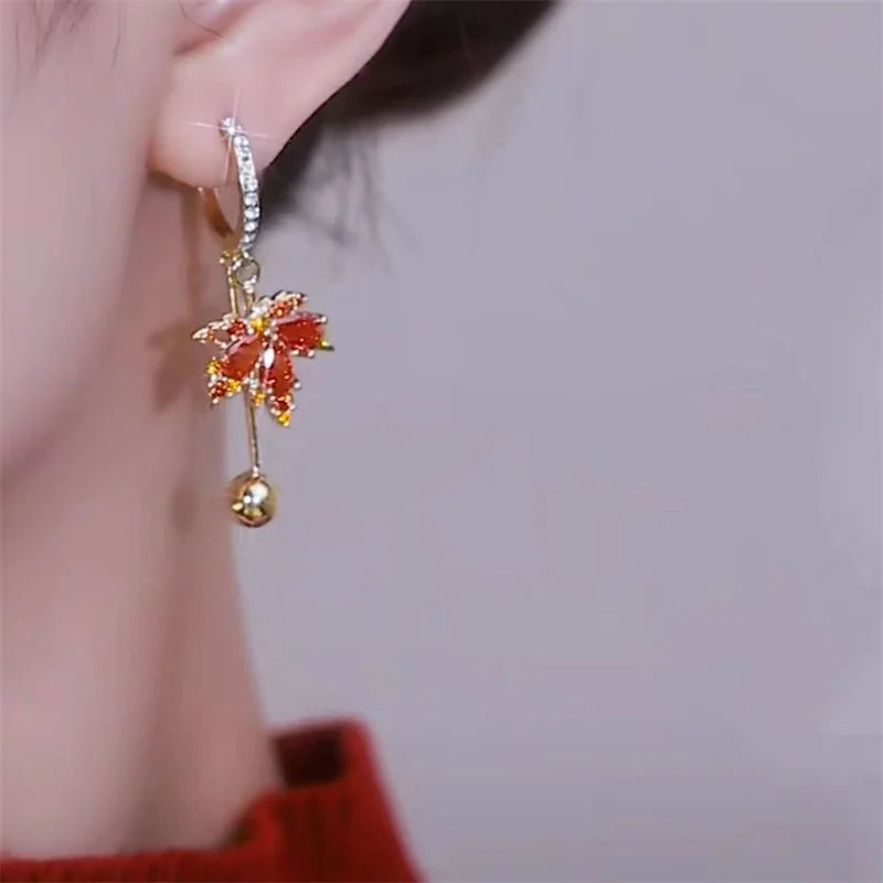 The allure of these exquisite French vintage earrings adorned with red maple leaf crystals and zircon stones. These elegant tassel earrings are designed to enhance a woman's temperament and add a touch of glamour to any party ensemble. They make a perfect gift for someone special who appreciates fine jewelry.